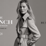 Kate Moss posing confidently in classic Burberry beige trench coat with belted waist and epaulettes, black-and-white portrait by Tim Walker for Burberry 170th anniversary The Trench Portraits of an Icon campaign